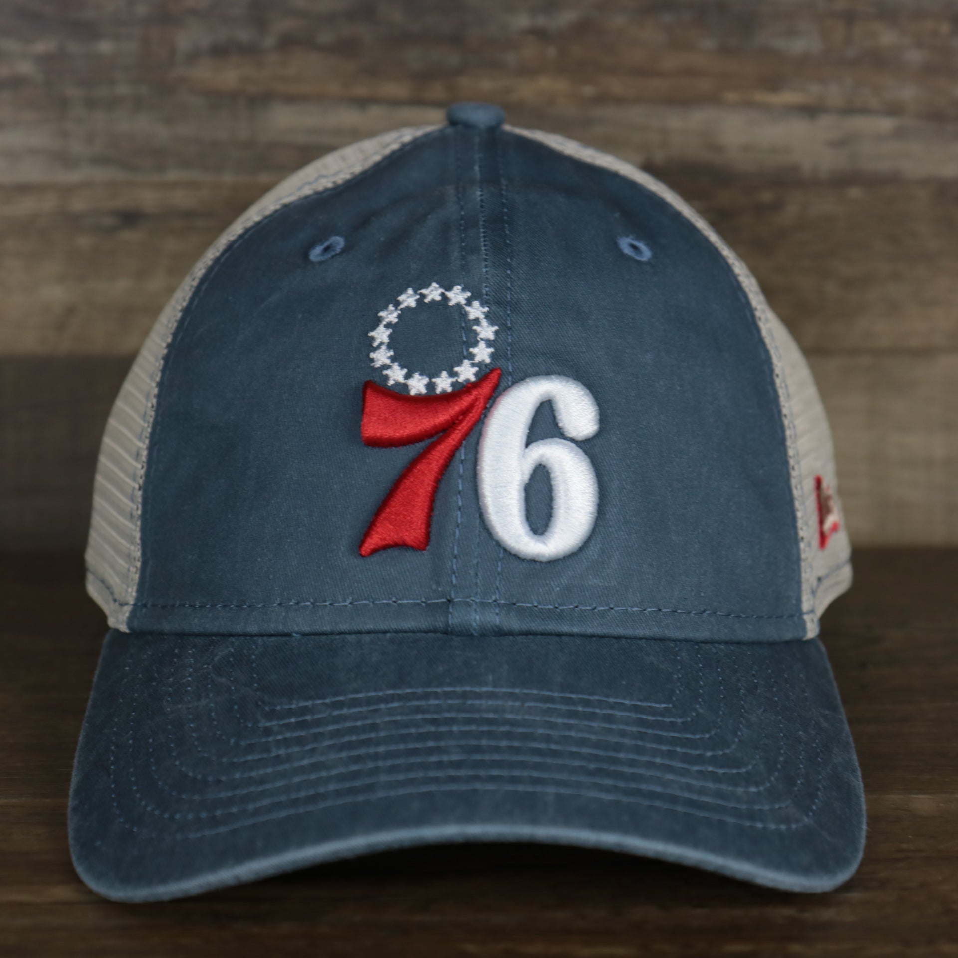 The front of the Philadelphia 76ers New Era 9Twenty Washed Trucker hat