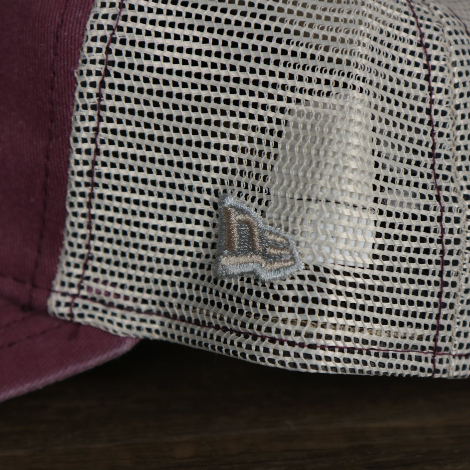 A close up of the New Era logo on the Philadelphia Phillies Cooperstown New Era 9Twenty Washed Trucker Youth hat