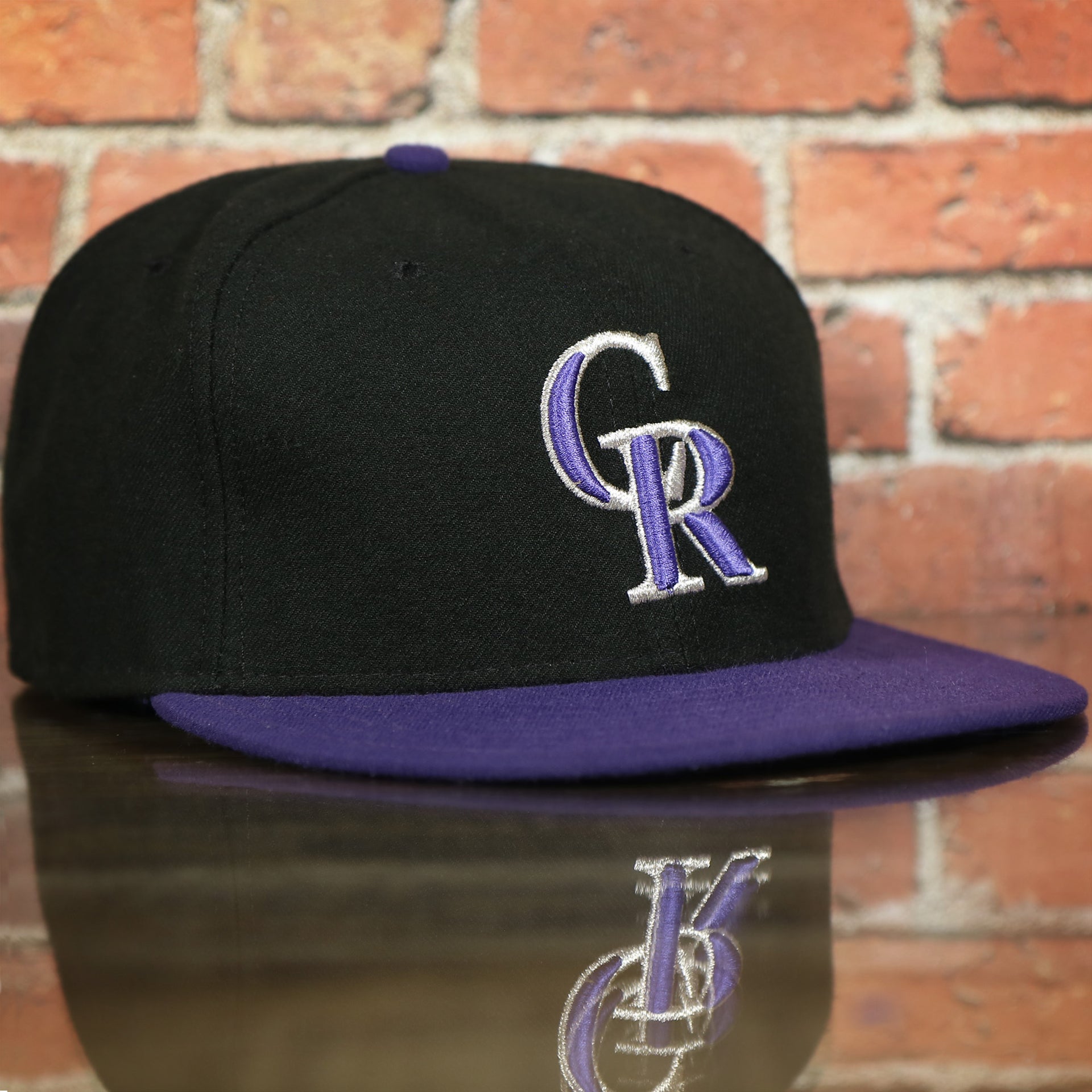 front of the Colorado Rockies MLB On-Field 59FIFTY Black and Purple Fitted Cap