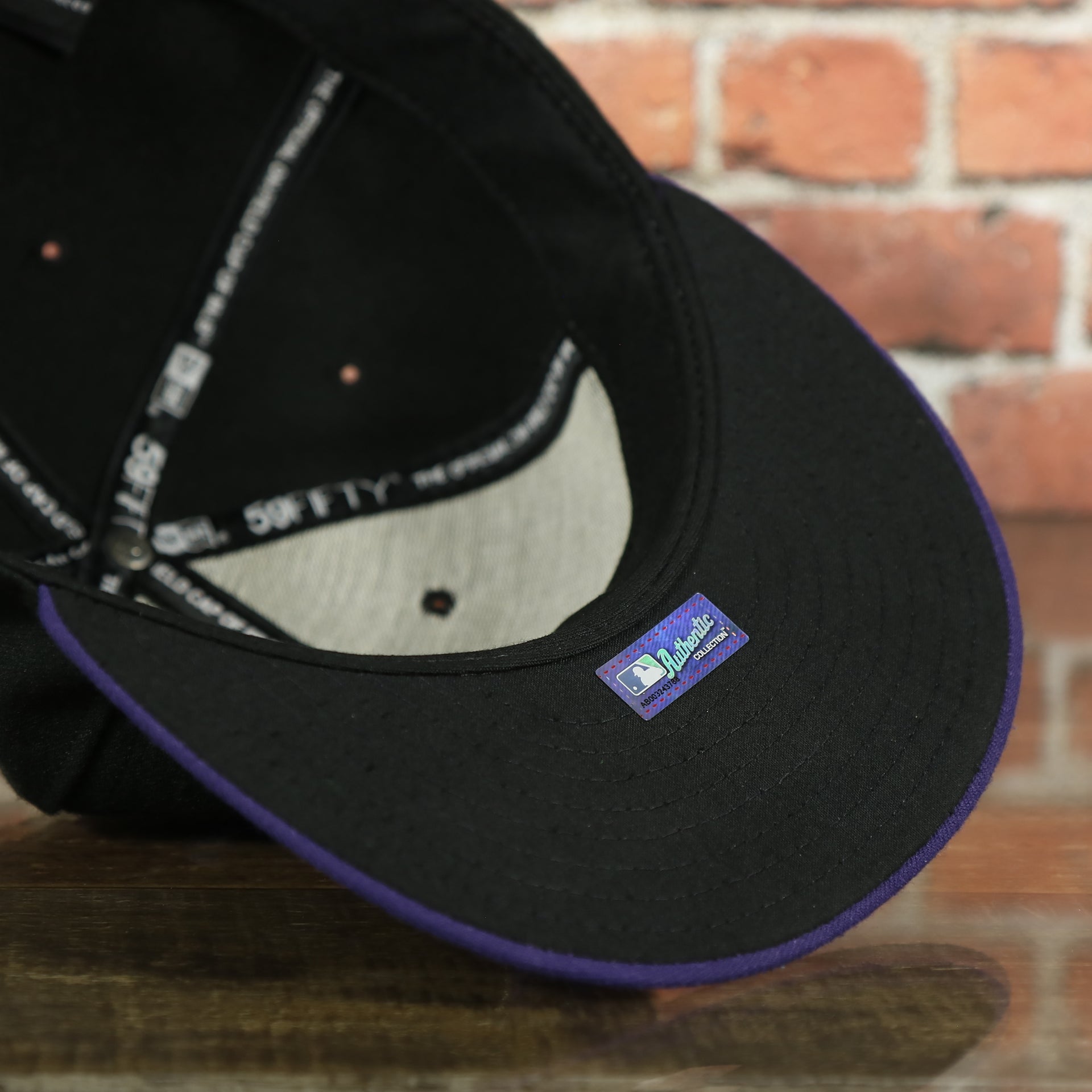 under side of the Colorado Rockies MLB On-Field 59FIFTY Black and Purple Fitted Cap