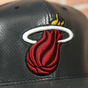 heats logo on the Miami Heat Perforated Leather Snapback | Black Miami Heat Snap Back with Racing Leather