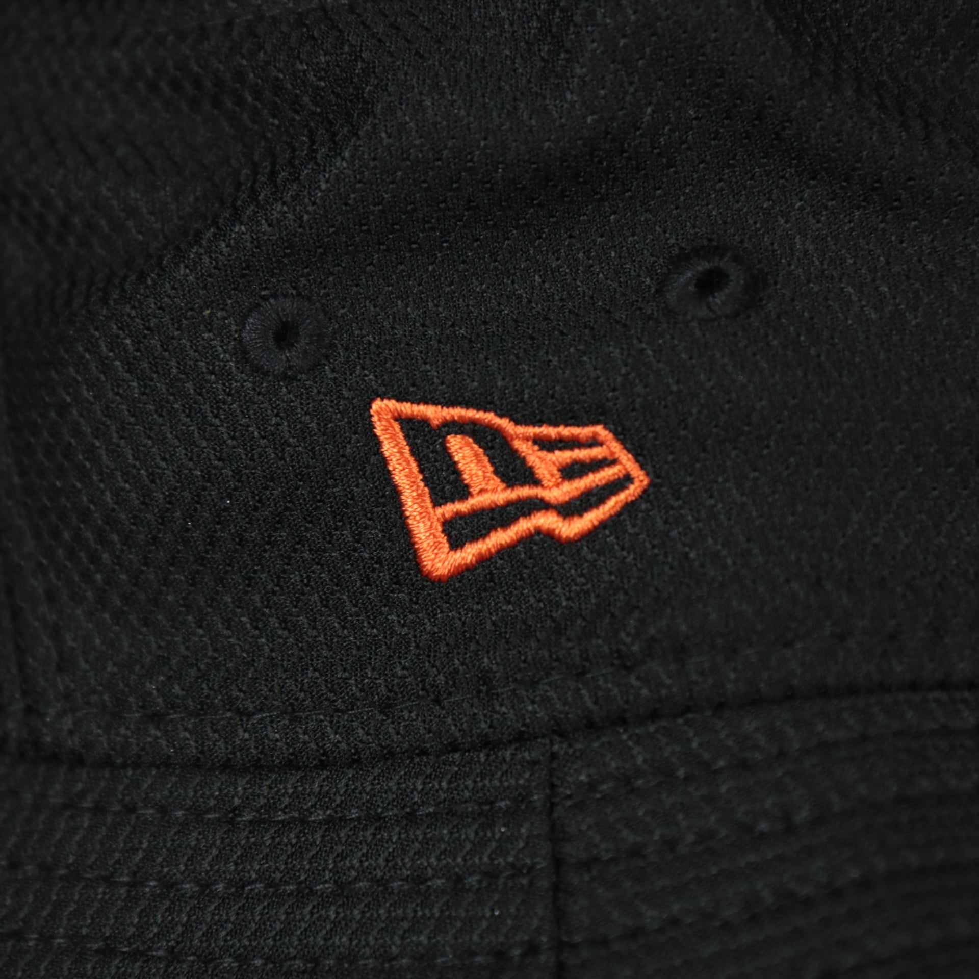 A close up of the New Era logo on the Baltimore Orioles MLB 2022 Spring Training Onfield Bucket Hat