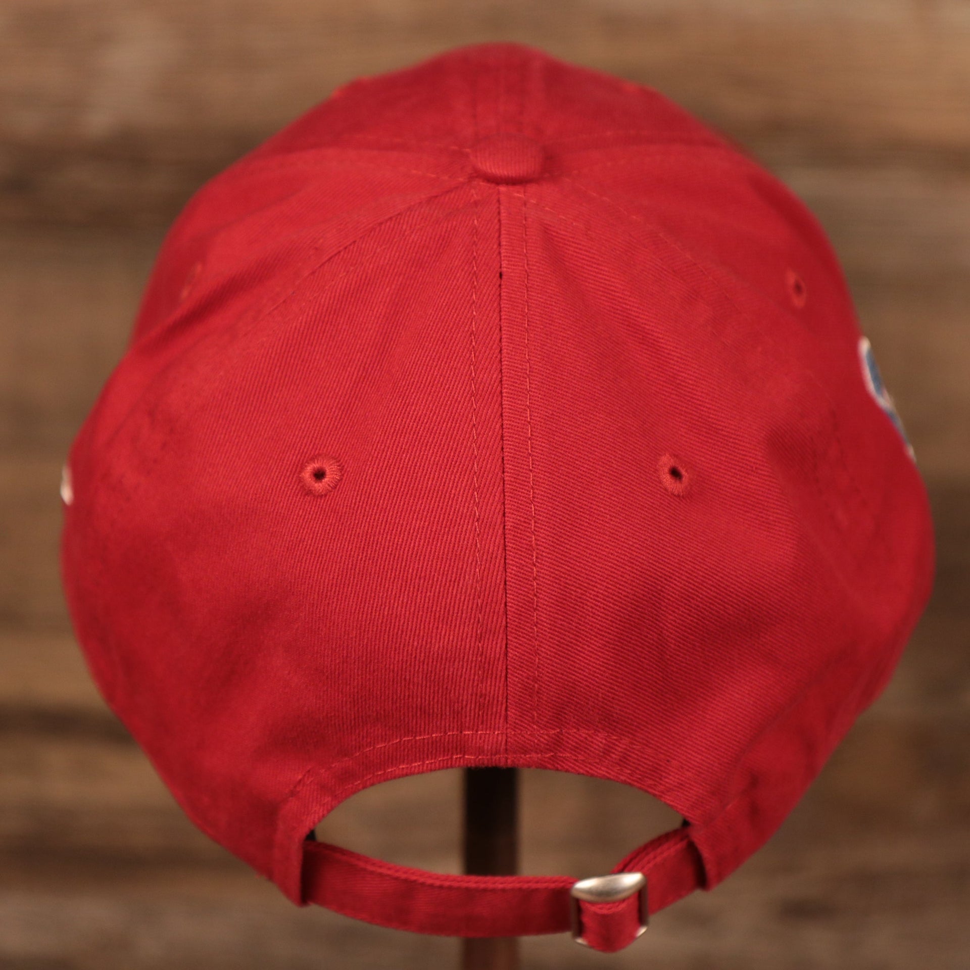 The adjustable strap at the backside of the red Philadelphia Phillies 9twenty MLB fathers day 2021 dad hat by New Era.