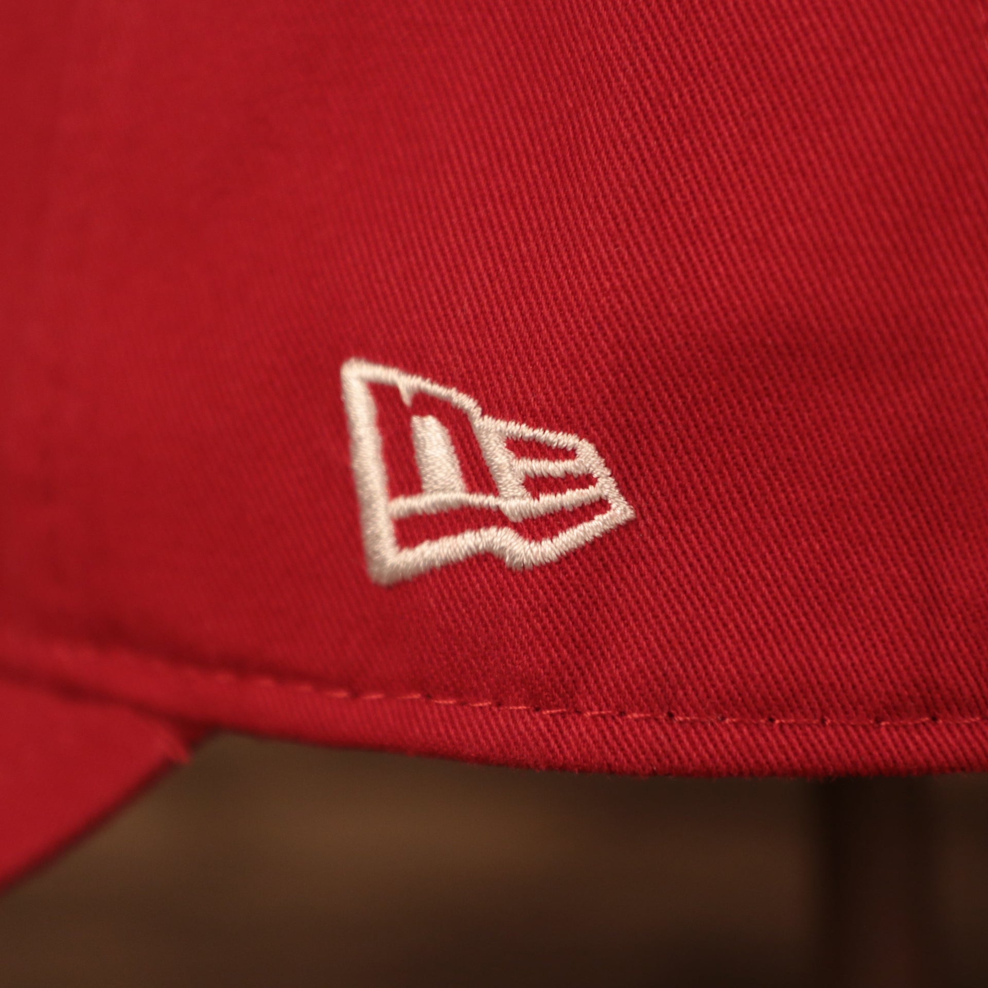 A close up of the white New Era patch on the left side of the Philadelphia Phillies red MLB on field fathers day 920 dad cap.
