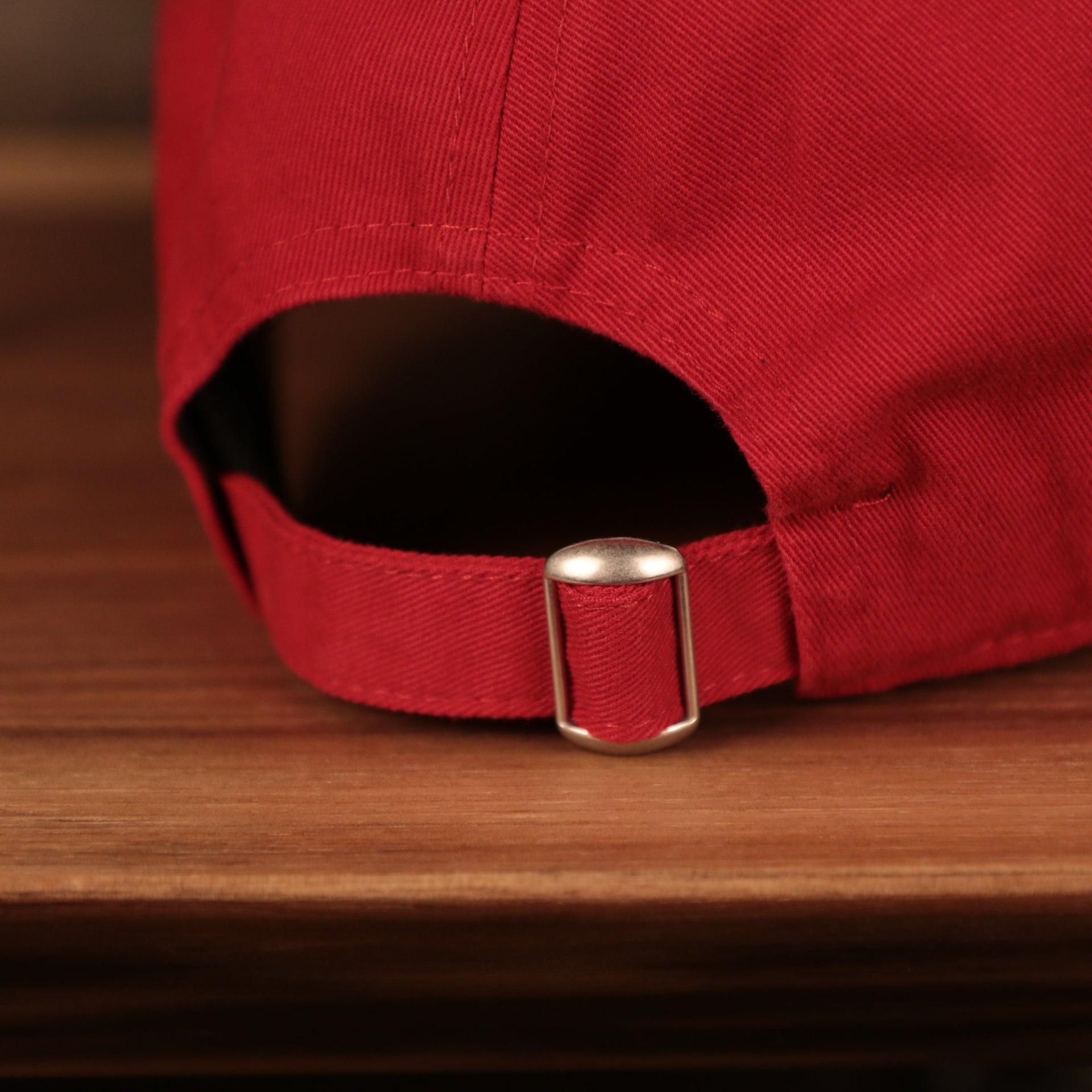 A closeup of the adjustable strap at the backside of the red Philadelphia Phillies 9twenty MLB fathers day 2021 dad hat by New Era.