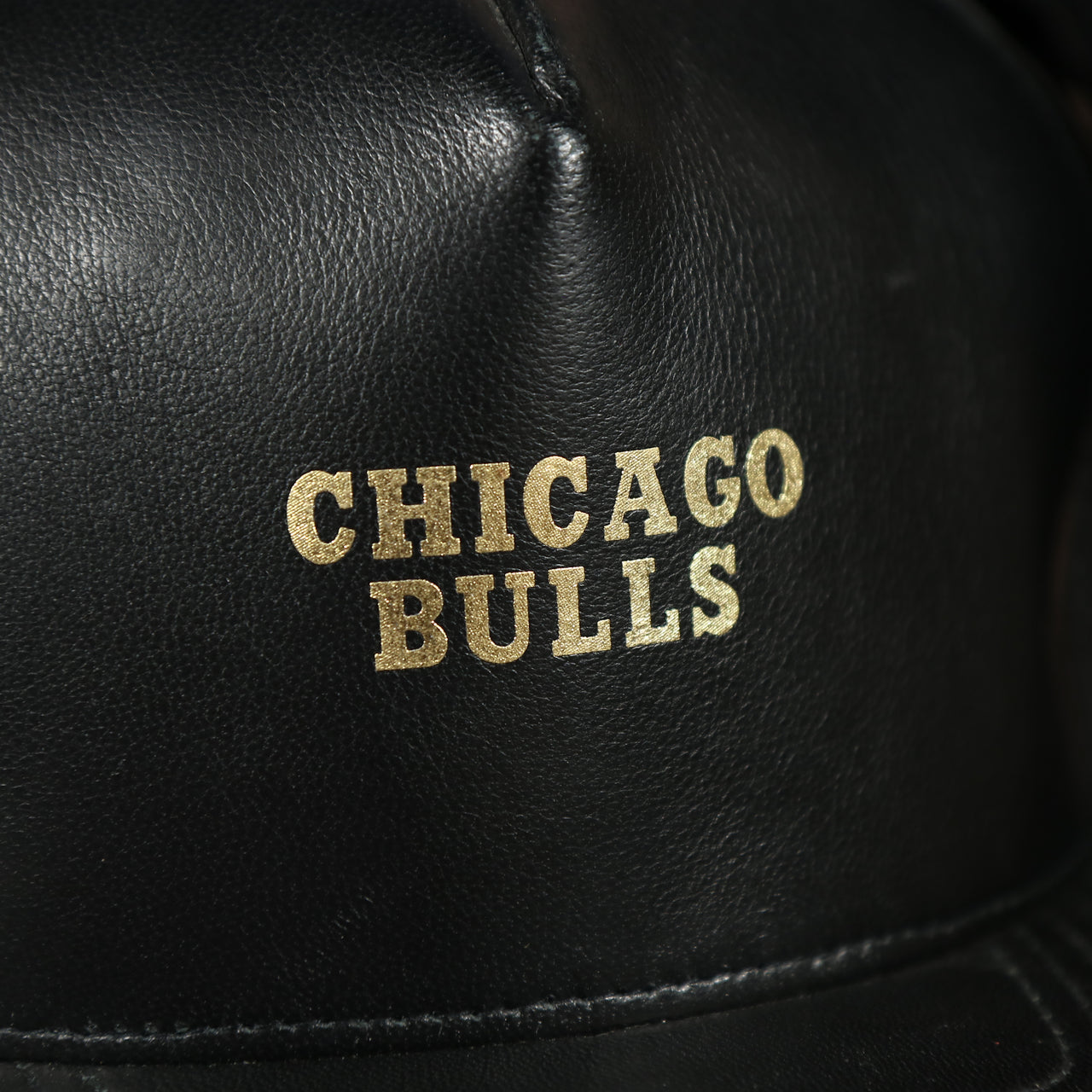 chicago bulls wordmark on the Chicago Bulls Leather Snapback | Black Bulls Snap Back with Gold Foil Design