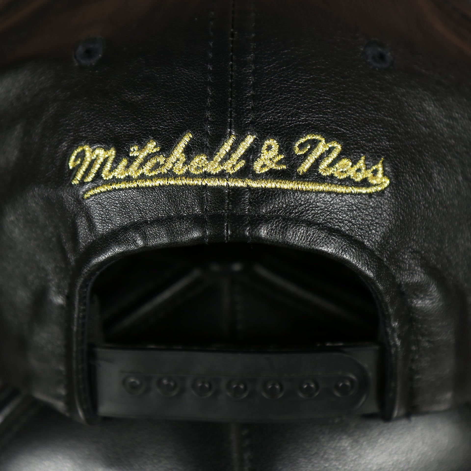 mitchell and ness logo on the Chicago Bulls Leather Snapback | Black Bulls Snap Back with Gold Foil Design