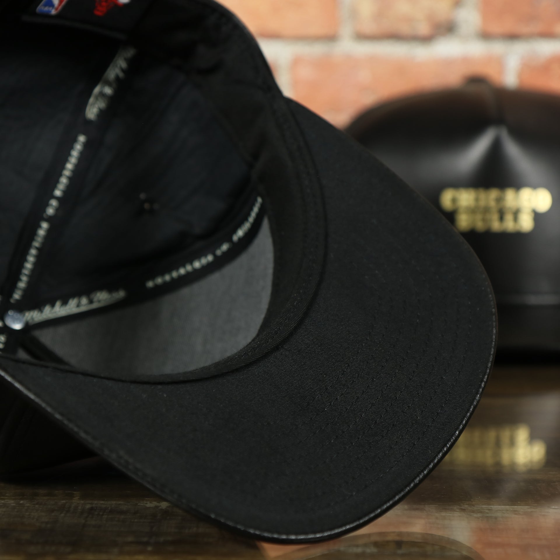 black under visor on the Chicago Bulls Leather Snapback | Black Bulls Snap Back with Gold Foil Design