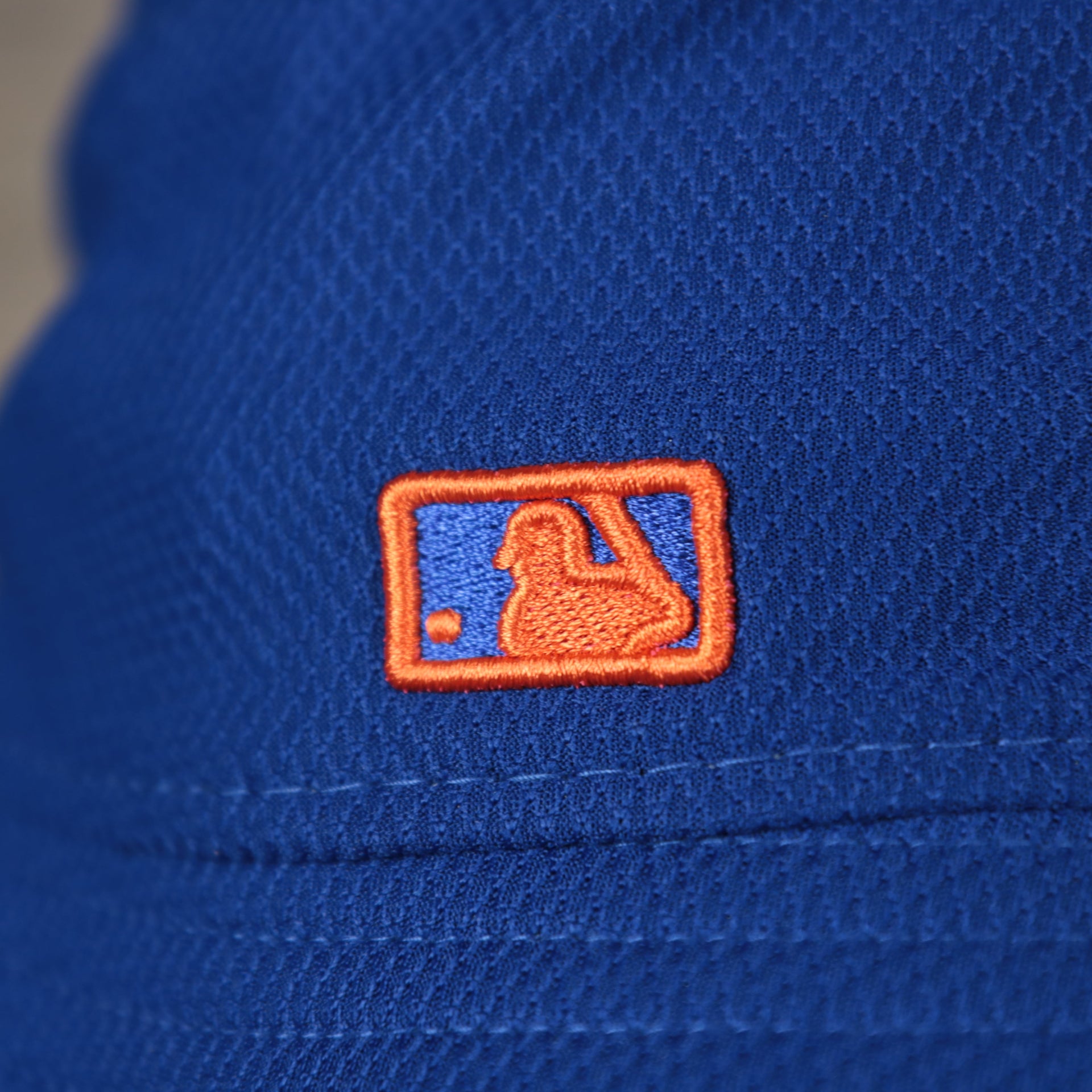 A close up of the MLB Batterman logo on the New York Mets  MLB 2022 Spring Training Onfield Bucket Hat