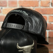black adjustable snap on the Chicago Bulls 100% Genuine Lambskin Leather Metallic Embossed Bull Logo Mitchell and Ness Black Snapback Hat