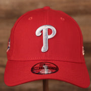The light blue fightin' Phils logo on the front side of the red New Era fathers day 2021 3930 flexfit cap.