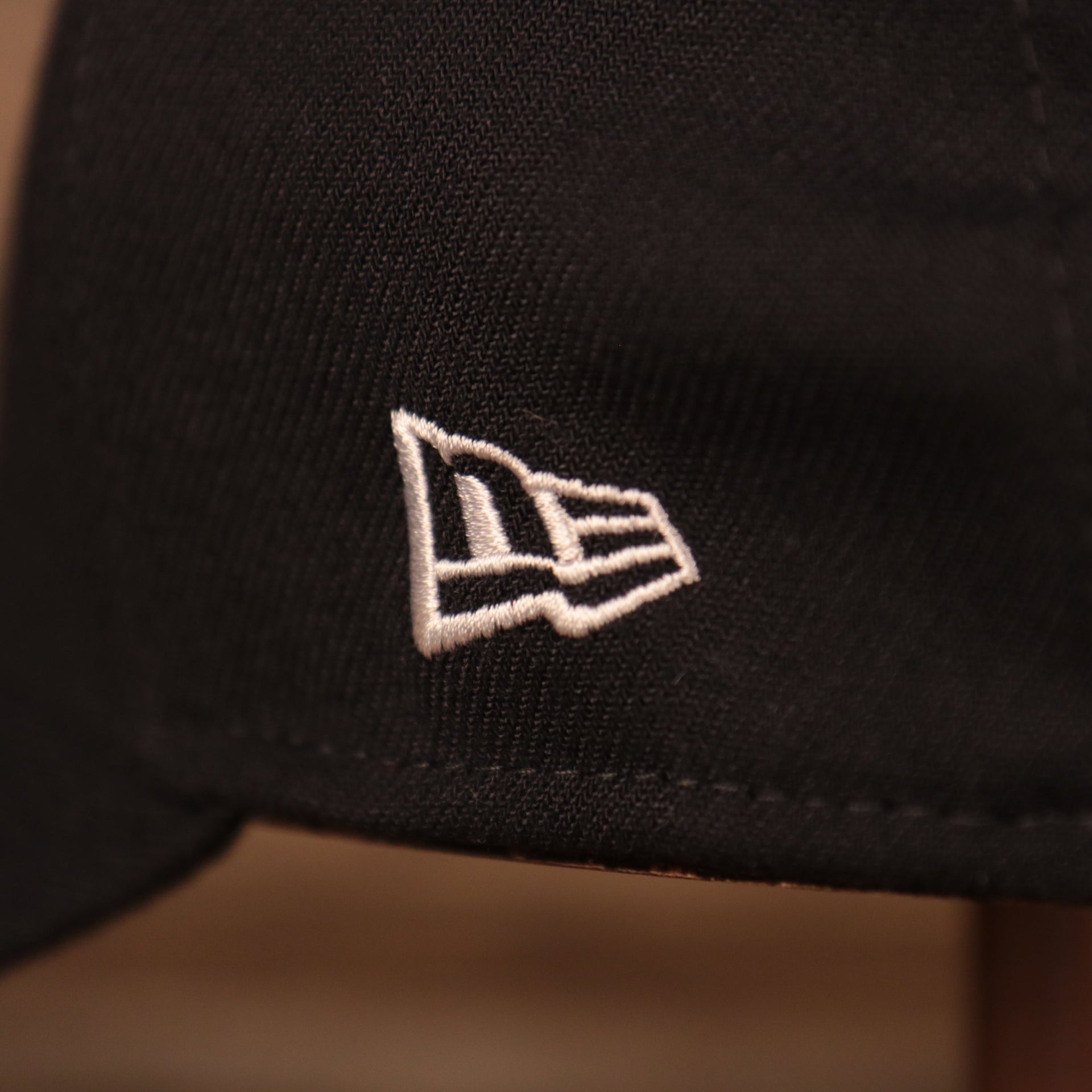 A close up of the white New Era patch on the left side of the navy blue Yankees MLB on field fathers day 39Thirty flexfit cap.