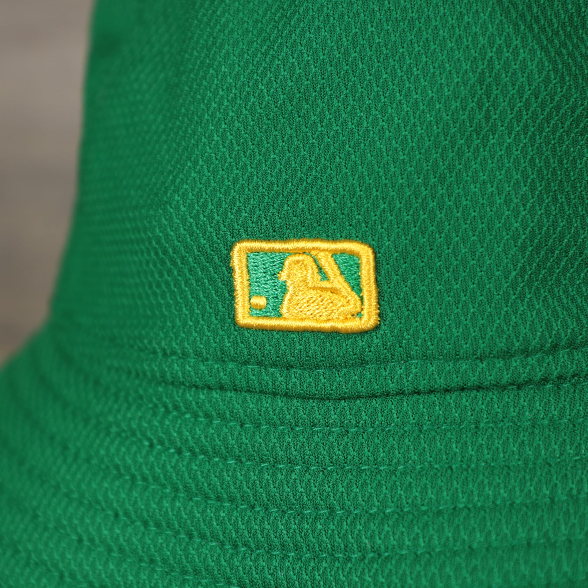 A close up of the MLB Batterman logo on the Oakland Athletics MLB 2022 Spring Training Onfield Bucket Hat