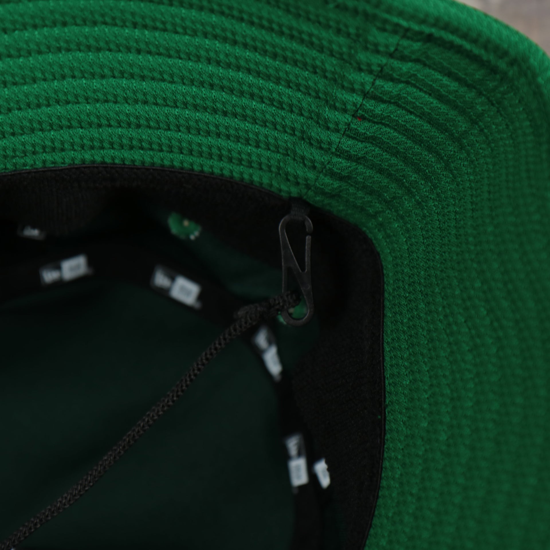 A close up of the removeable chin strap on the Oakland Athletics MLB 2022 Spring Training Onfield Bucket Hat