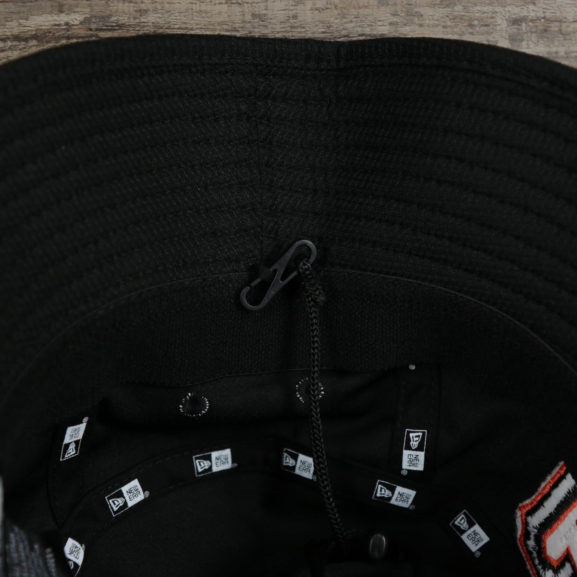 A close up of the removable chin strap on the San Francisco Giants MLB 2022 Spring Training Onfield Bucket Hat