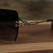 The hinge on the Large Lightweight Frame Black Lens Sunglasses with Gold Frame
