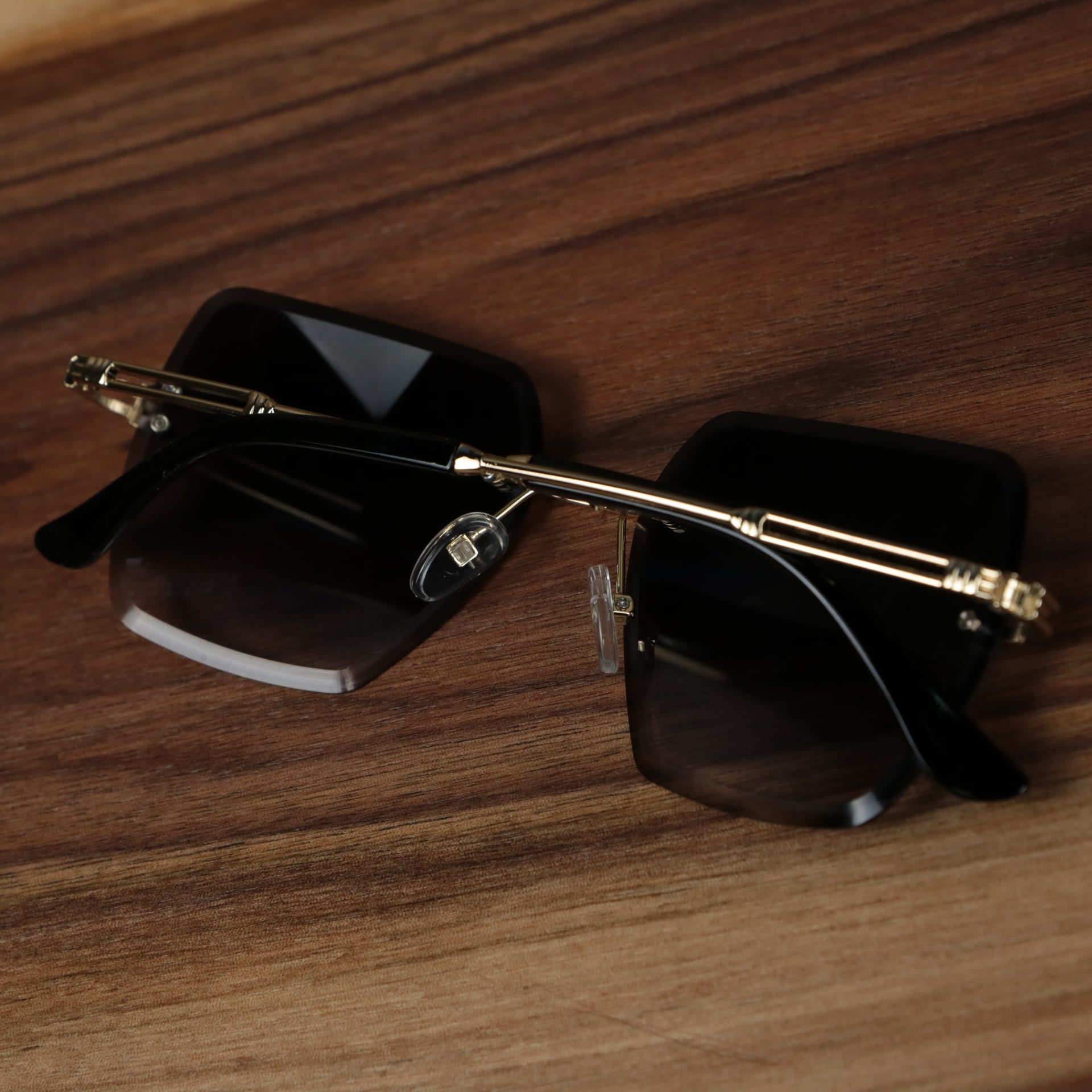 The Large Lightweight Frame Black Lens Sunglasses with Gold Frame folded up