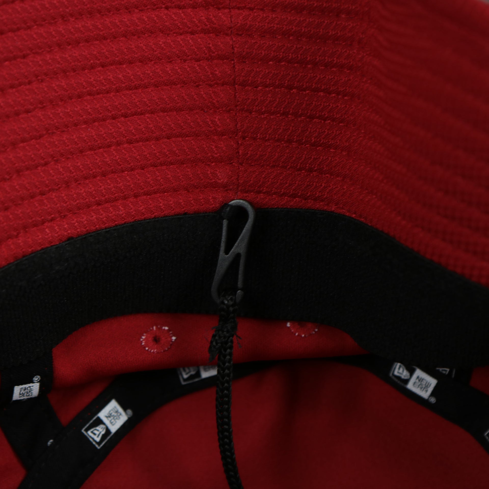 A close up of the removeable chin strap on the Cincinnati Reds MLB 2022 Spring Training Onfield Bucket Hat
