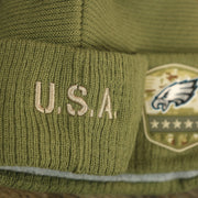The USA Wordmark on the Philadelphia Eagles Salute To Service Ribbon Rubber Military Eagles Patch On Field NFL Beanie | Military Green Beanie