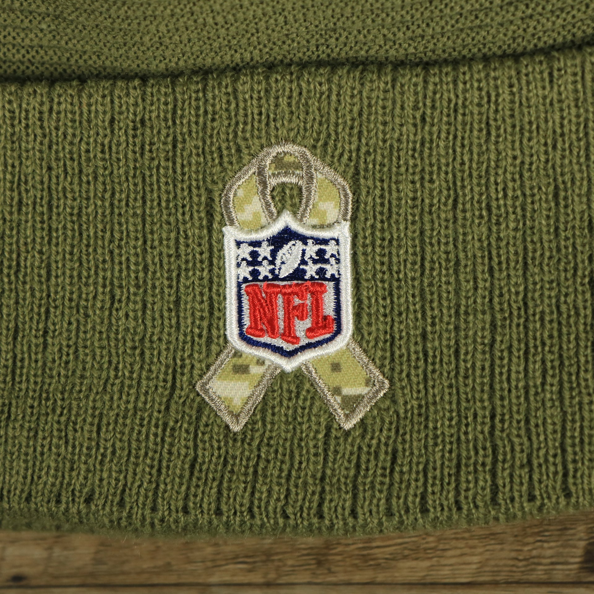 The NFL Ribbon on the Philadelphia Eagles Salute To Service Ribbon Rubber Military Eagles Patch On Field NFL Beanie | Military Green Beanie