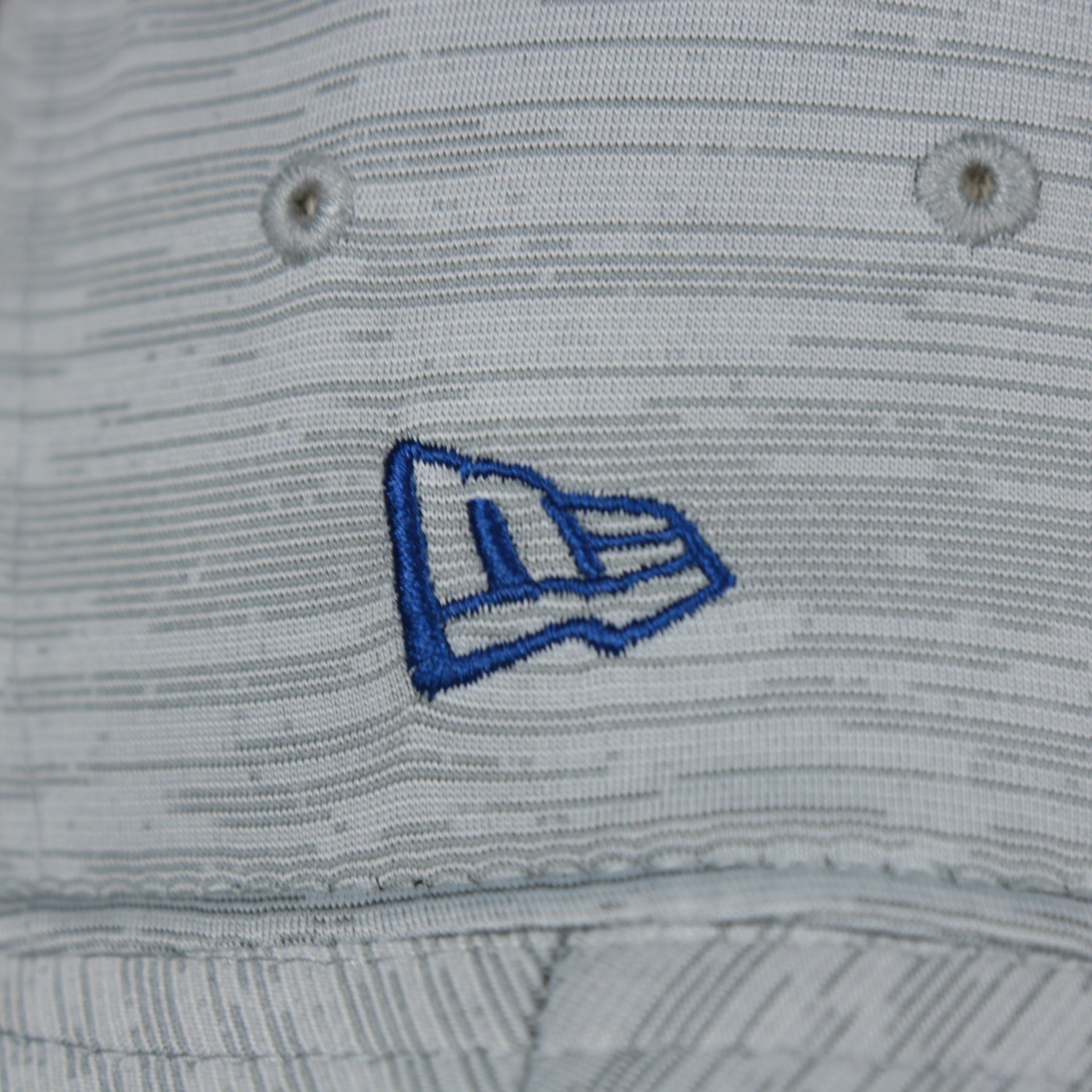 A close up of the New Era logo on the Philadelphia 76ers New Era Bucket Hat