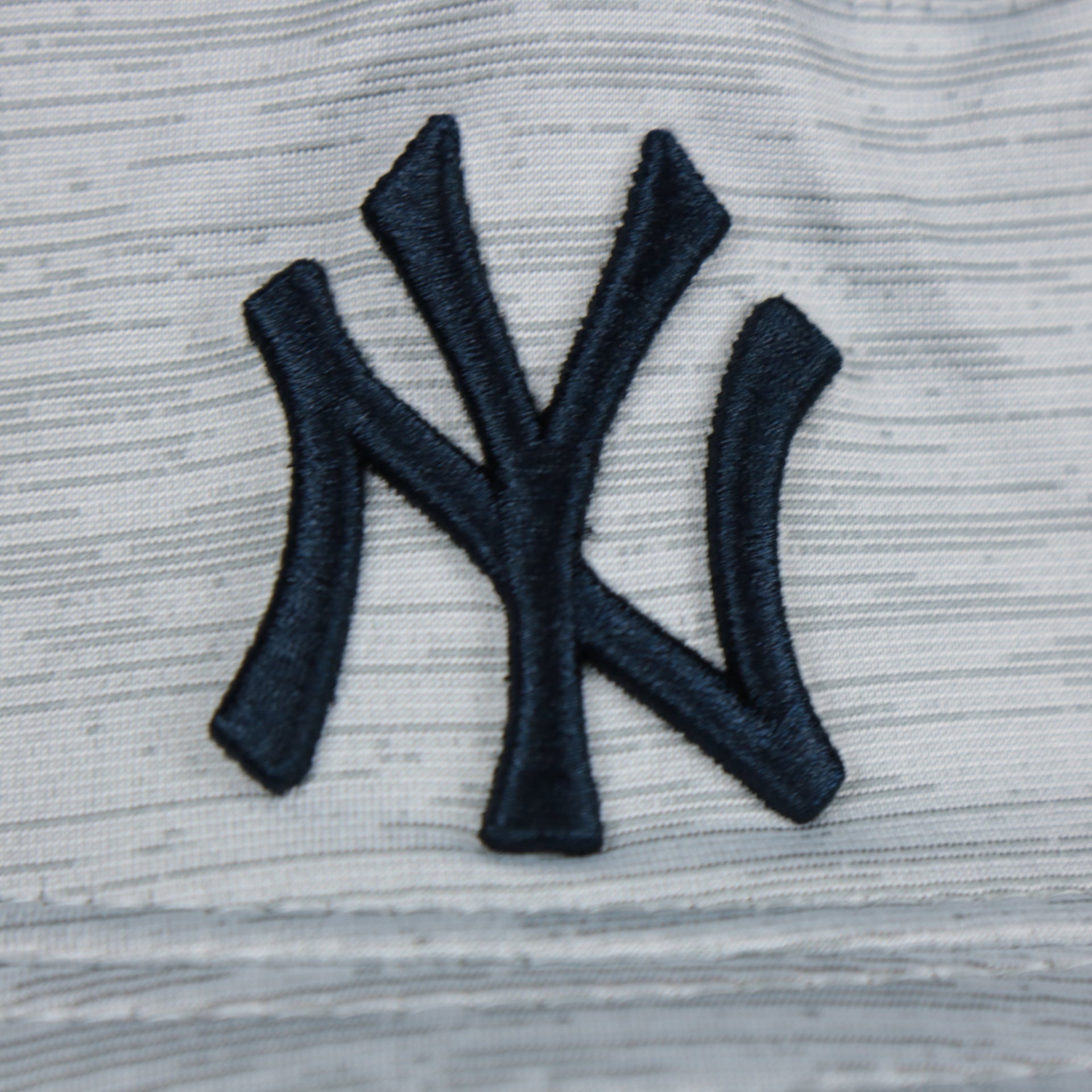 A close up of the Yankees logo on the New York Yankees New Era Bucket Hat