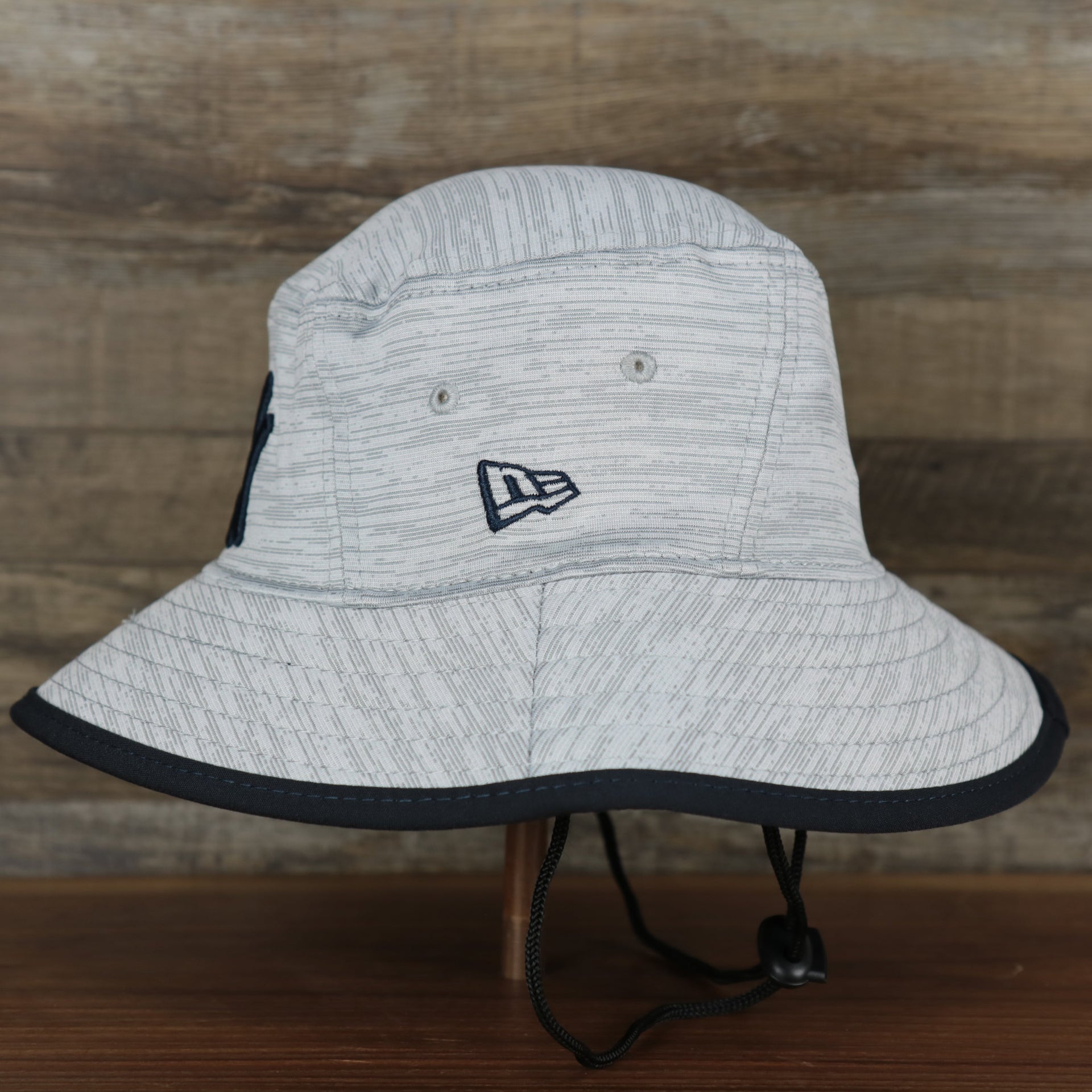 The wearer's left on the New York Yankees New Era Bucket Hat