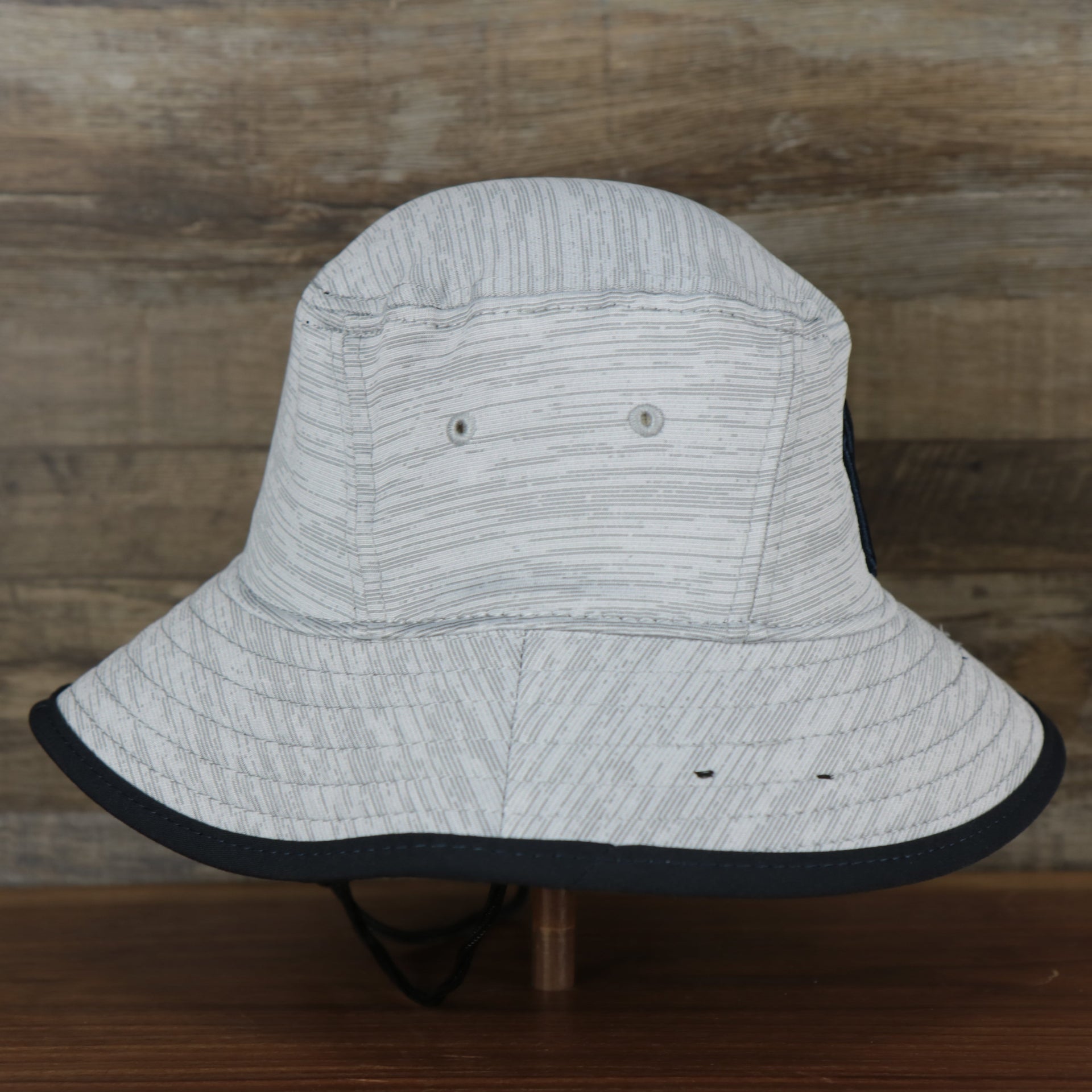 The wearer's right on the New York Yankees New Era Bucket Hat