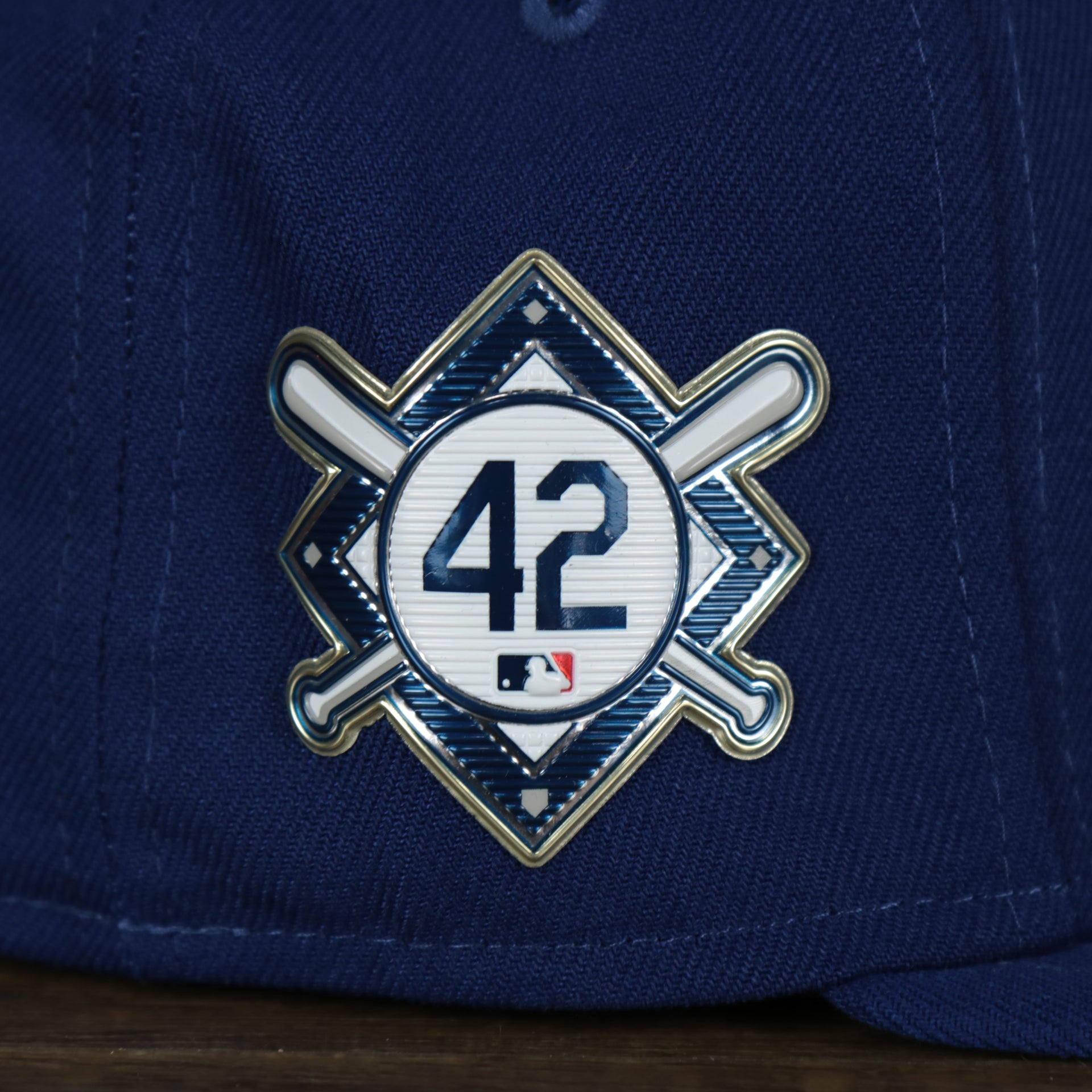 A close up of the number 42 side patch on the Los Angeles Dodgers Jackie Robinson Side Patch 59Fifty Black Bottom Fitted Cap