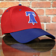 front side of the Philadelphia Phillies Liberty Bell Logo Blue Bottom 39Thirty Stretch Fit Cap | Red and Blue