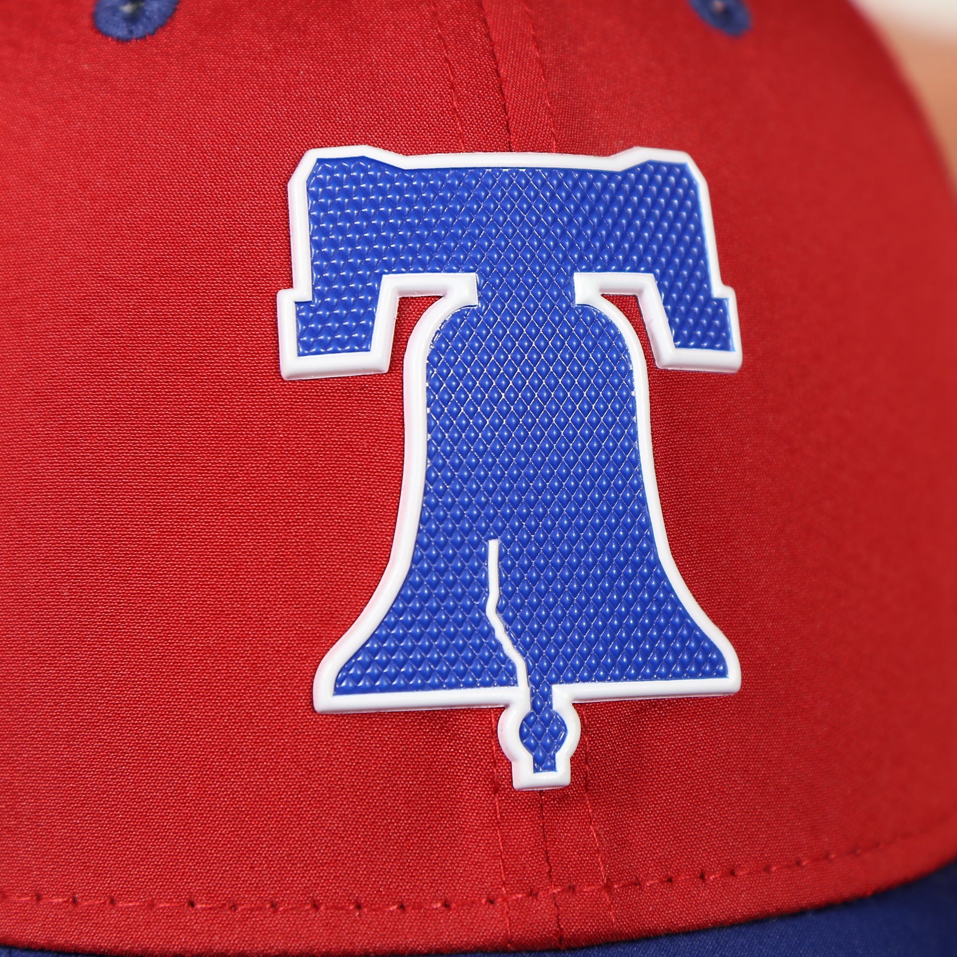 liberty bell logo on the Philadelphia Phillies Team Classic Blue on Red 39Thirty Stretch Fit Cap