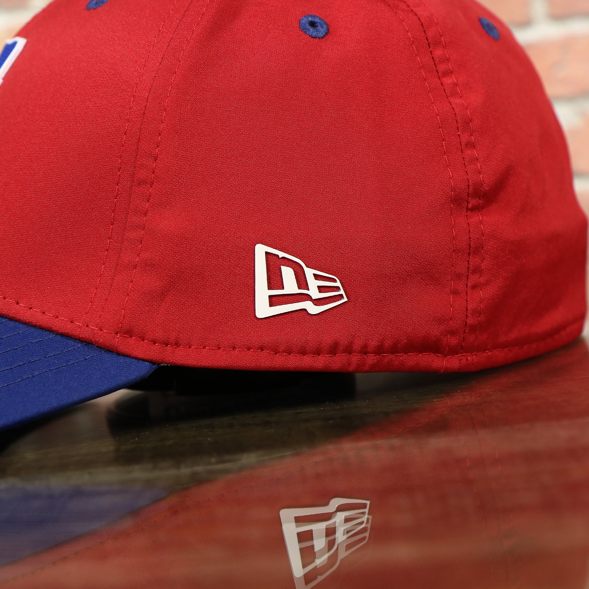 new era logo on the Philadelphia Phillies Team Classic Blue on Red 39Thirty Stretch Fit Cap