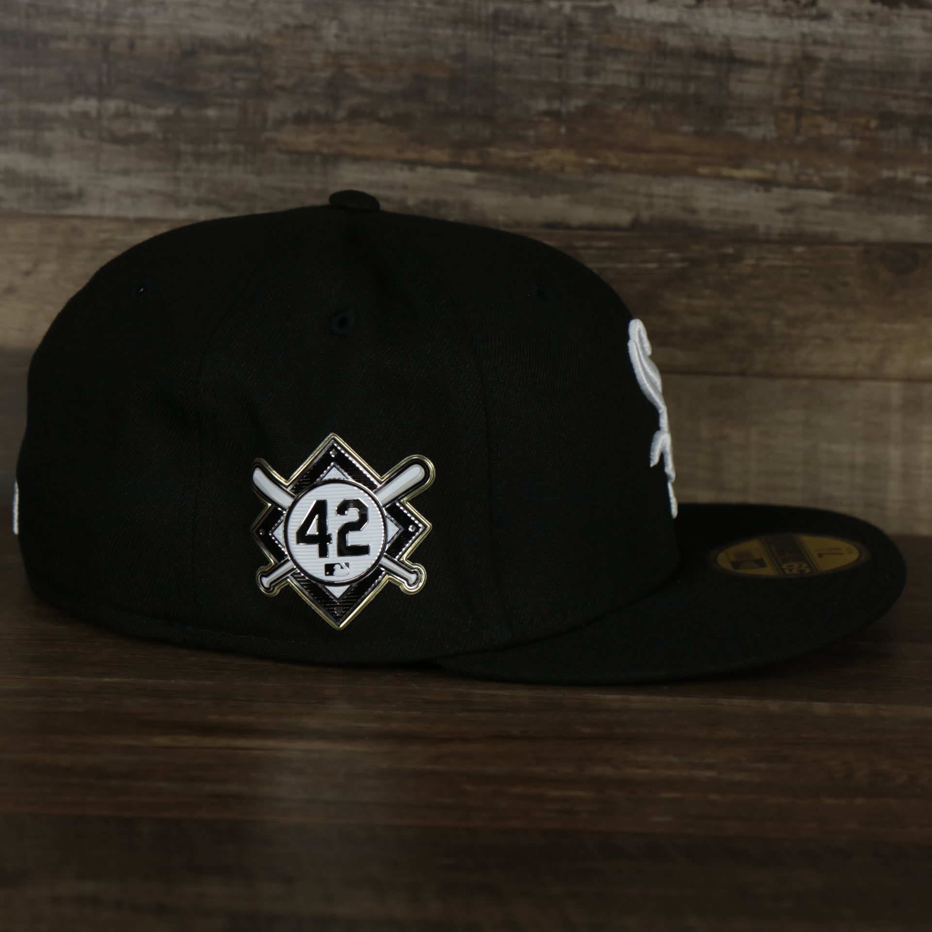 The wearer's right on the Chicago White Sox Jackie Robinson Side Patch 59Fifty Black Bottom Fitted Cap