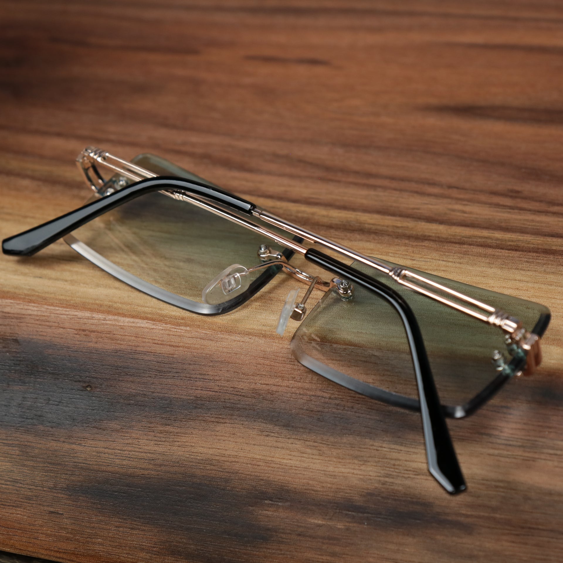 The Rectangle Frame Green Lens Sunglasses with Gold Frame folded up