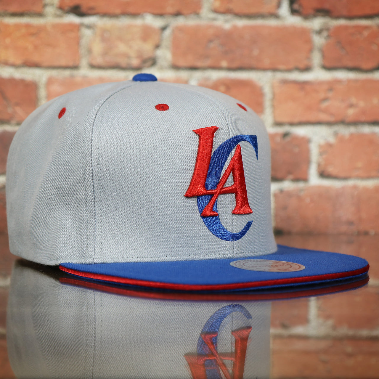 front of the Los Angeles Clippers Vintage Logo Adjustable Snapback with Blue Under visor | Grey OSFM