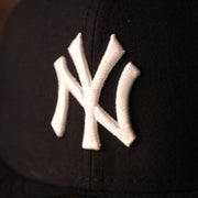 the Yankees logo on the front is white Yankees Black Bottom Fitted Cap | New York Yankees On-Field Black Underbrim Fitted Hat