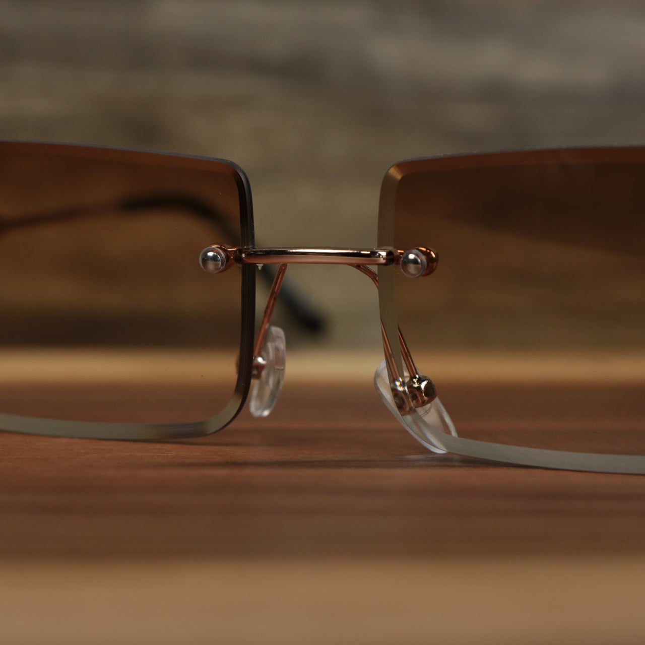The bridge on the Rectangle Frame Brown Lens Sunglasses with Gold Frame
