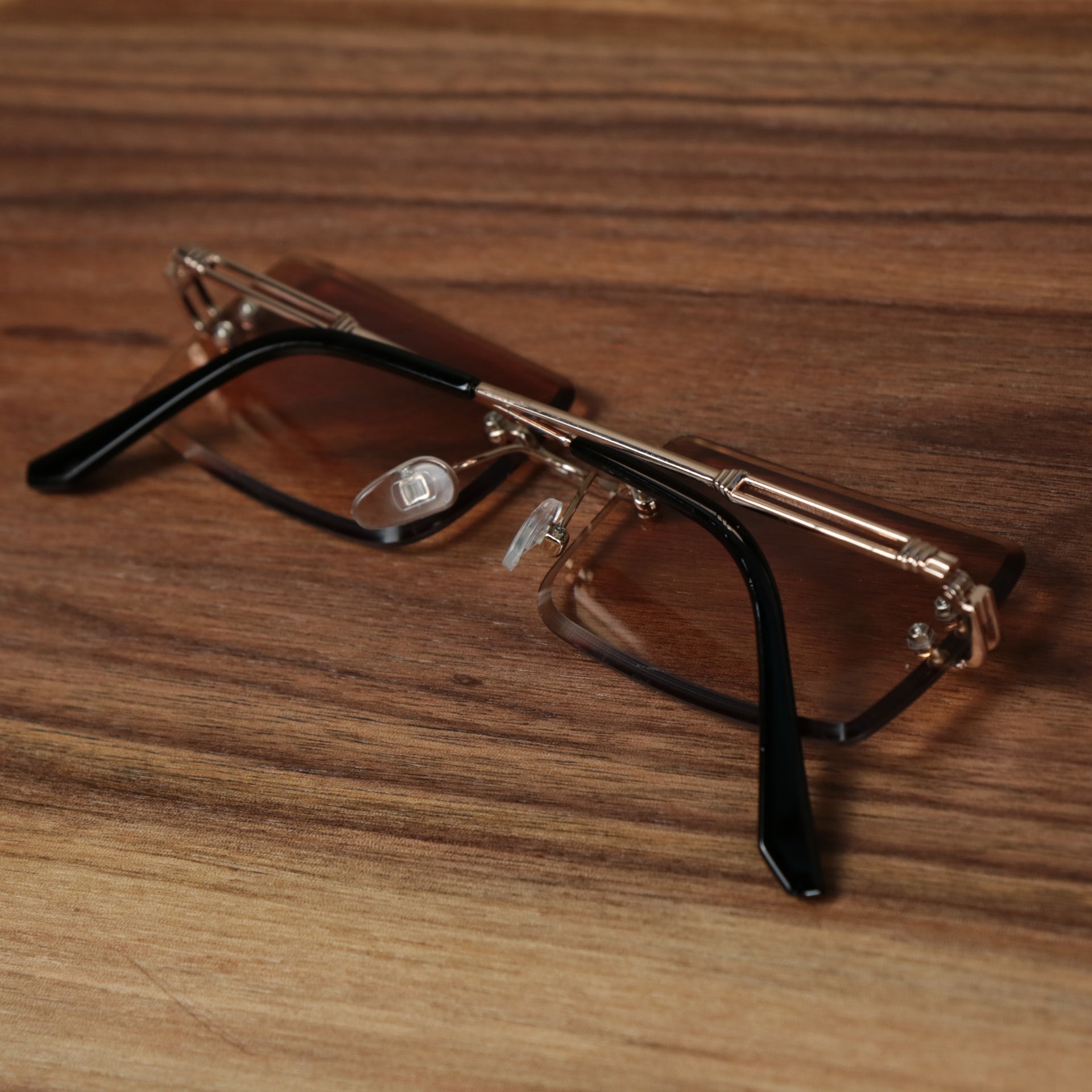 The Rectangle Frame Brown Lens Sunglasses with Gold Frame folded up