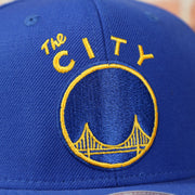 the city logo on the front of the Golden State Warriors The City Logo Adjustable Snapback with Green Under visor | Blue OSFM