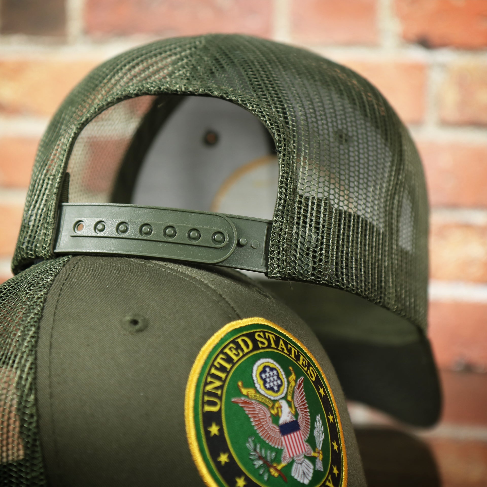 back side of the US Army Seal Logo Mesh Back Olive Trucker Snapback Hat | Olive OSFM
