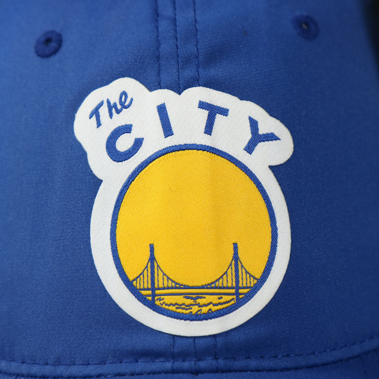 the city logo on the Golden State Warriors Dry Poly Blue Dad Hat