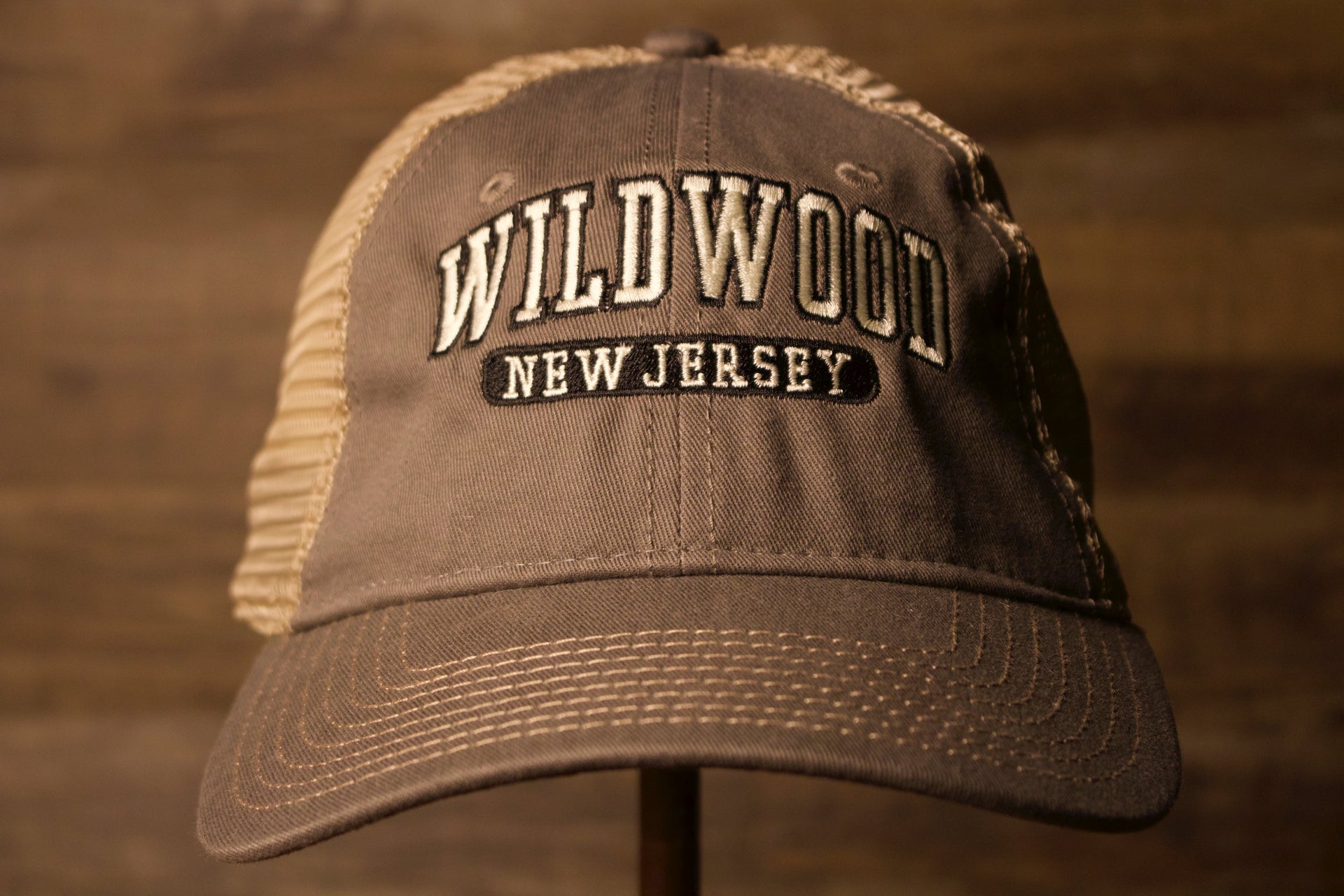 Wildwood New Jersey Charcoal / Khaki Mesh-Back Trucker Hat the front of this hat has Wildwood and new jersey with a charcoal color Wildwood New Jersey Charcoal / Khaki Mesh-Back Trucker Hat