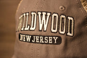 wildwood is white and outlined in black Wildwood New Jersey Charcoal / Khaki Mesh-Back Trucker Hat