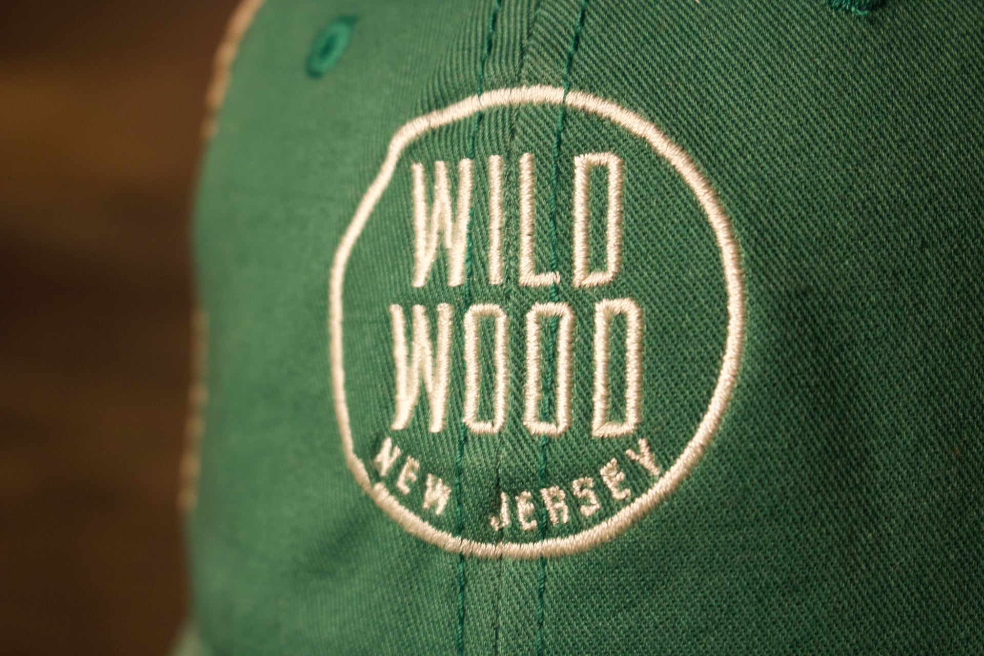 the text is white and its inside a white circle Wildwood New Jersey Kelly Green / Khaki Mesh-Back Trucker Hat