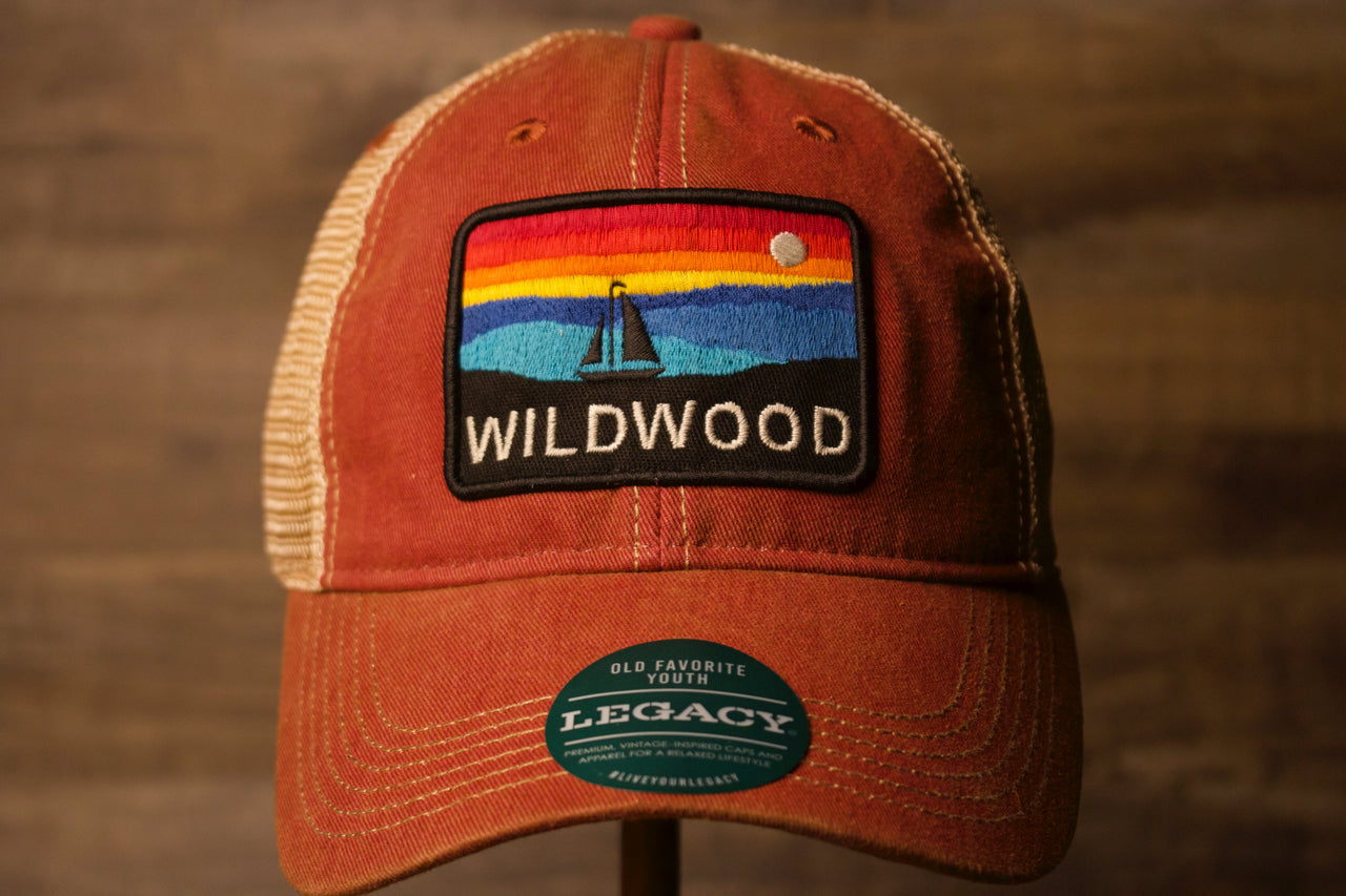 Wildwood kid's hat | Youth Wildwood NJ Cardinal Mesh-back Trucker Hat the front of this trucker hat has the name wildwood with a sunset and boat as well