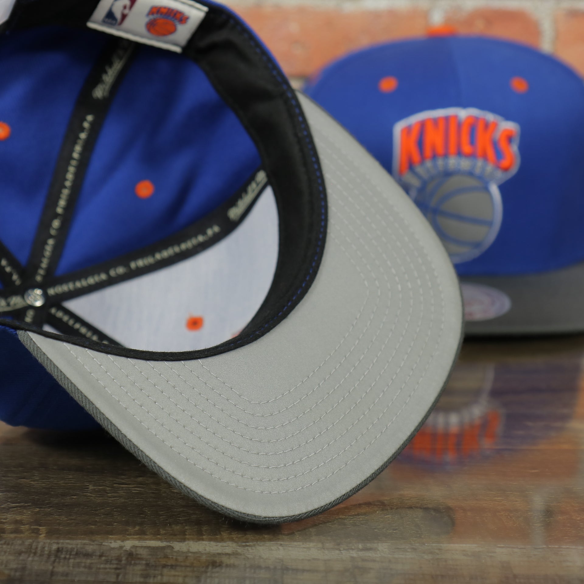 gray under visor on the Knicks Gray Bottom Snapback | New York Knicks Retro Grey Bottom Snap Cap