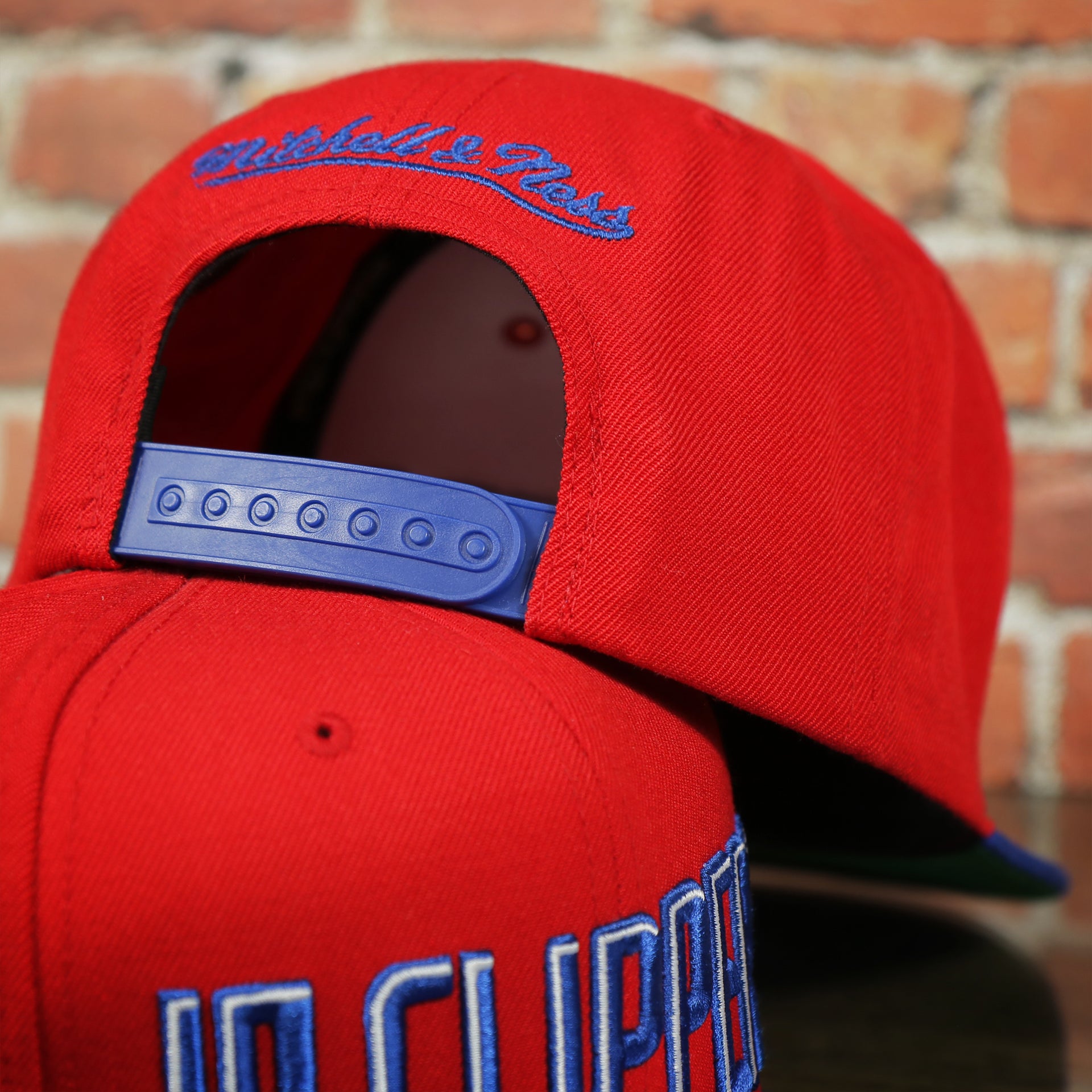 royal blue adjustable snap on the Los Angeles Clippers XL Logo Red Snapback Hat | LA Clippers Big Logo Green Bottom Snap Back