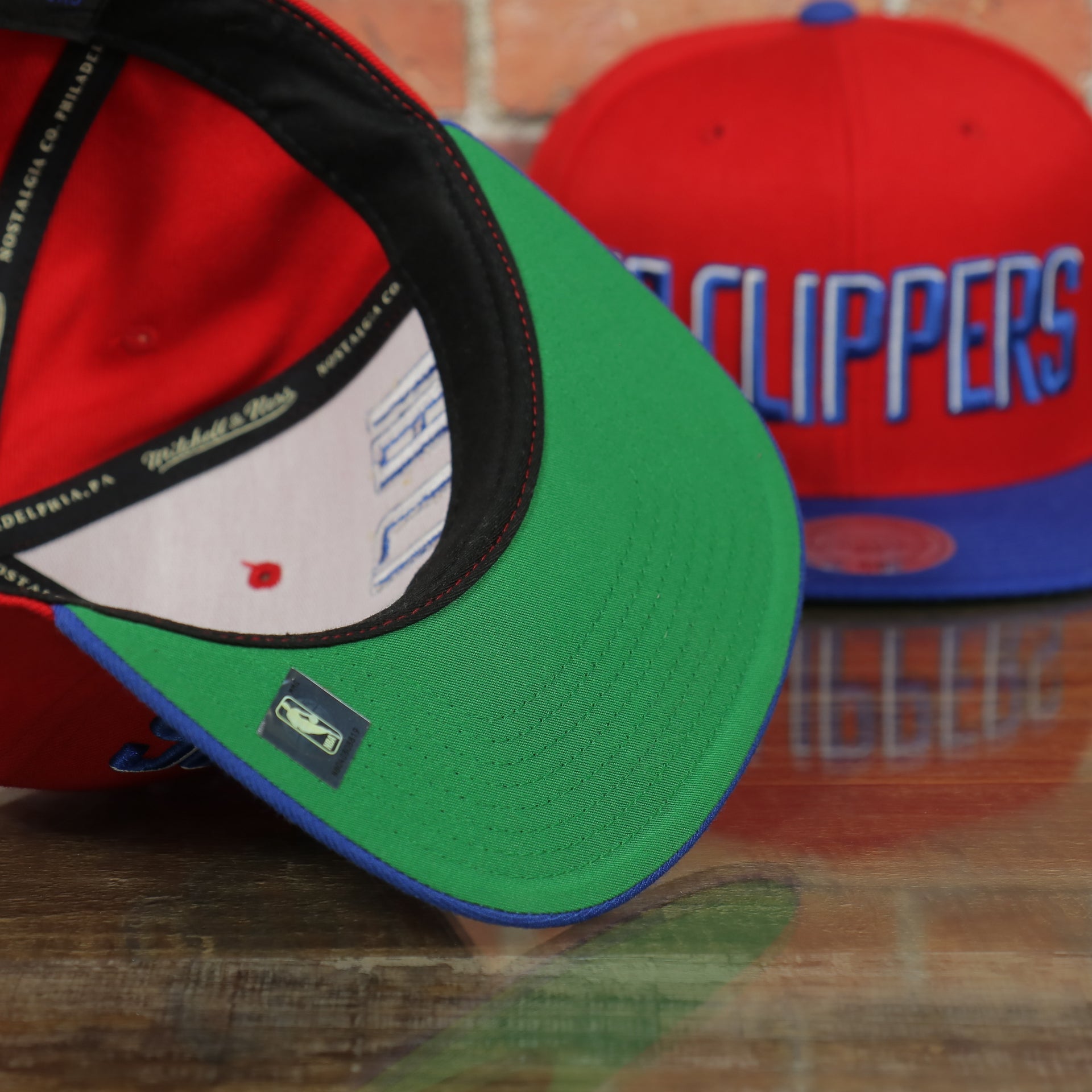 green under visor on the Los Angeles Clippers XL Logo Red Snapback Hat | LA Clippers Big Logo Green Bottom Snap Back
