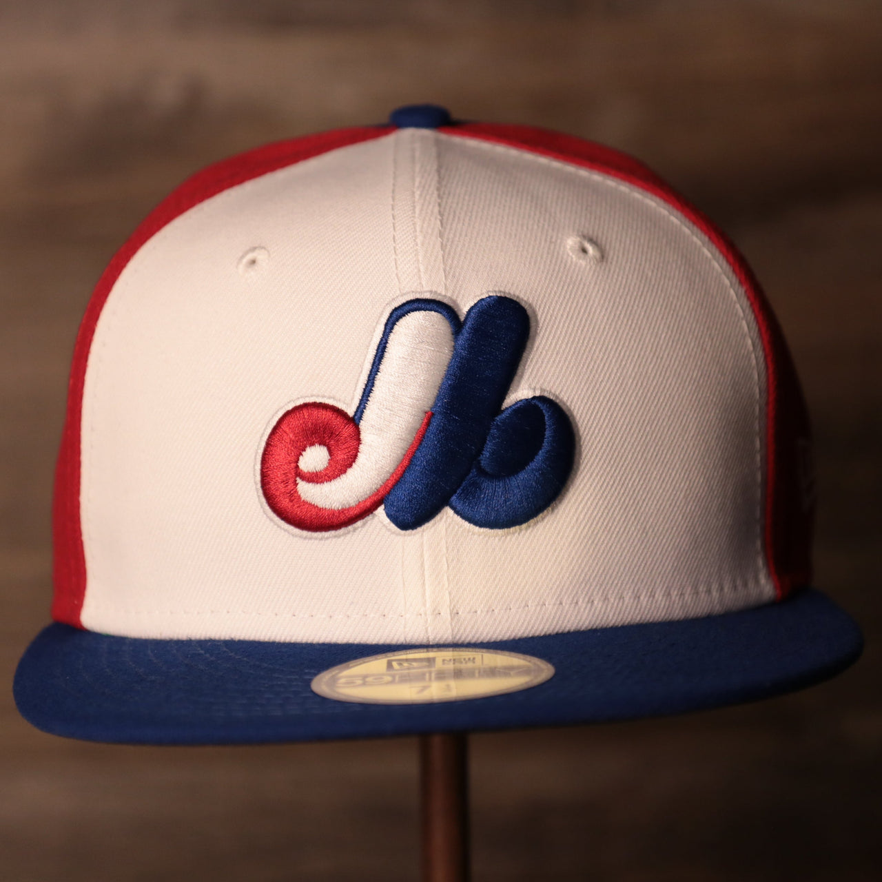 The front side of this New Era 59fifty has the logo of the Montreal Expos in white, red and blue.