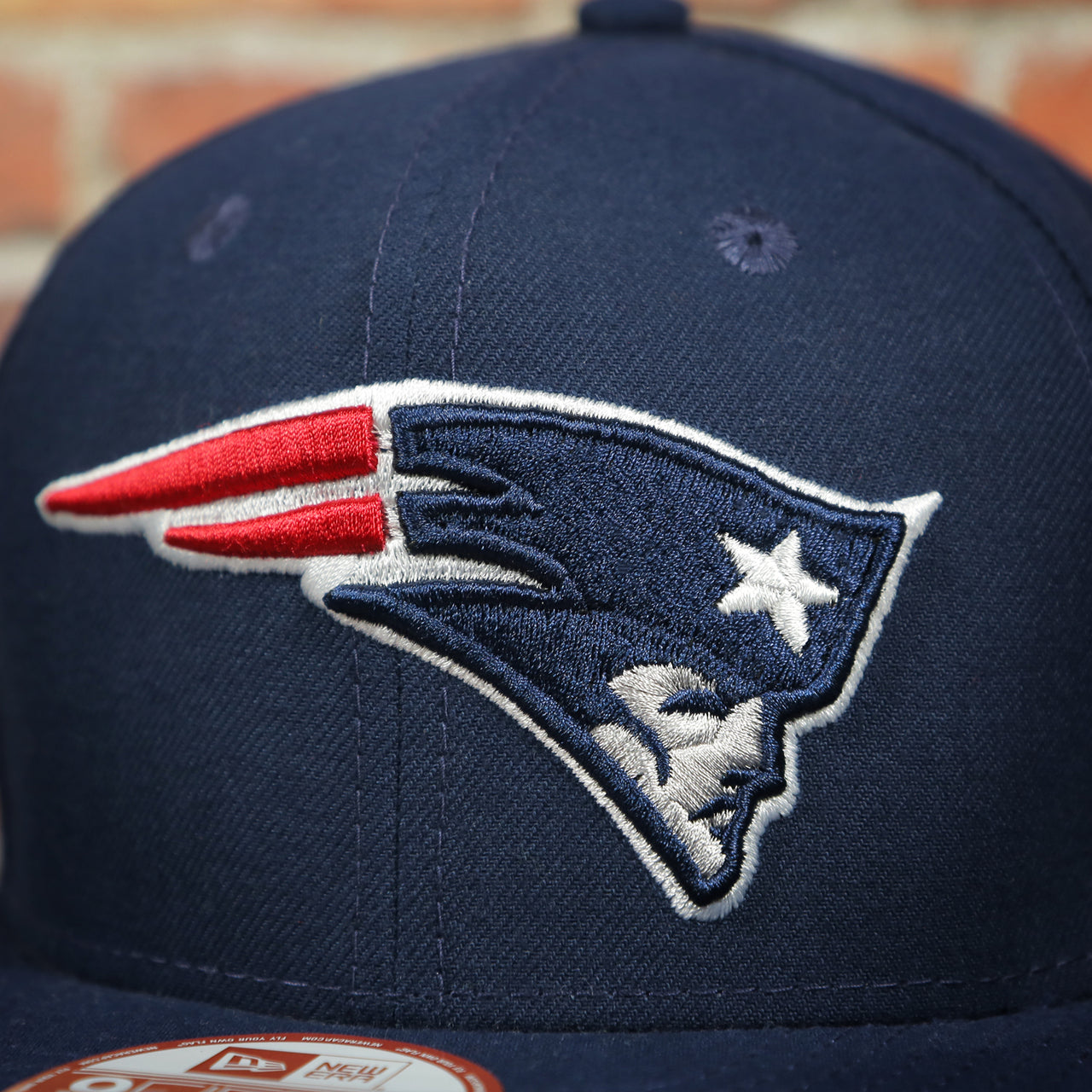 patriots logo on the New England Patriots Throwback 4X Super Bowl Champions Snapback Hat